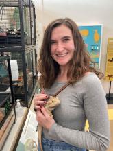 This is an image of Ms. Rajnowski holding a bearded dragon.