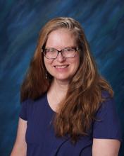 a school picture of Susan Harelson, a woman with long hair and glasses.